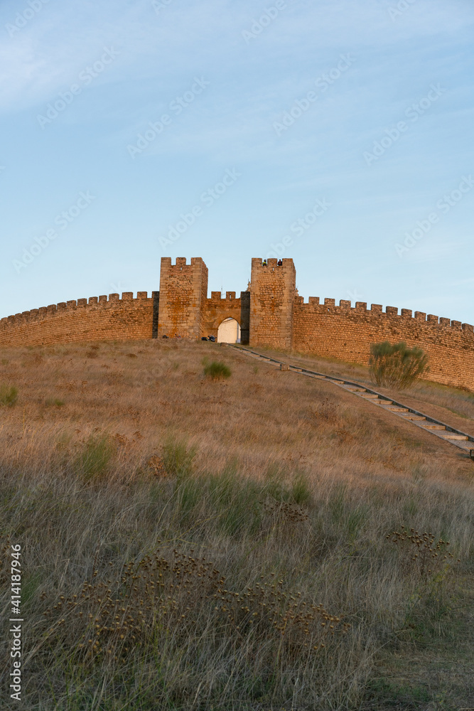 View of Arraiolos castle on top of the hill in Alentejo, Portugal at sunset