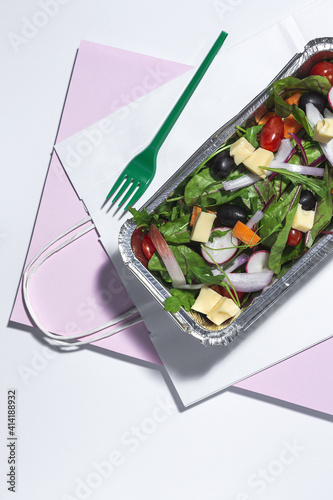 Healthy vegan take away salad in aluminum container