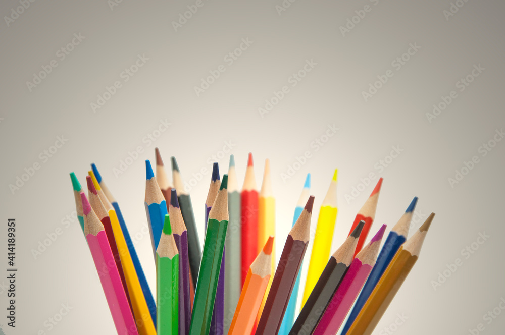colored pencils on gray background. education concept. illustration of training.