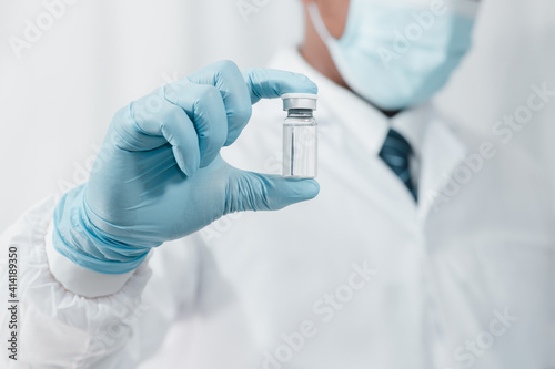 doctor with gloves. Coronavirus vaccine COVID-19 Coronavirus vaccine in a glass bottle.