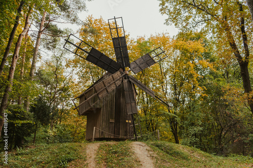 Wooden windmill in a forest autumn colors