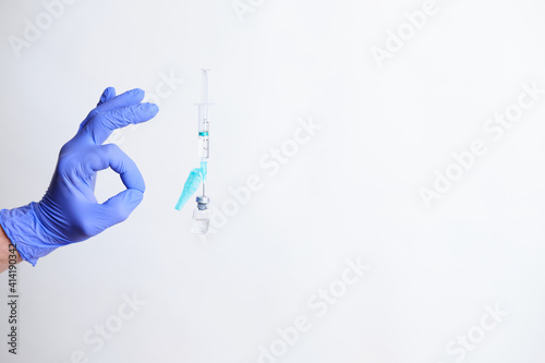 Hand with surgical gloves doing ok symbol on a white background