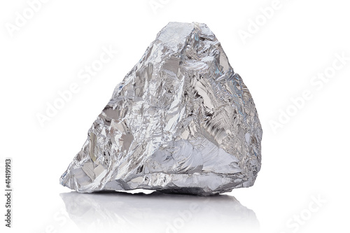 Macro shoot of piece of nickel metal ore isolated on a white background. Closeup photo of amazing shiny mineral rough photo