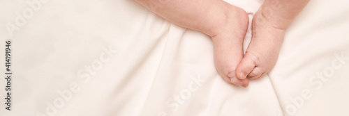 Little child feet. Toddler legs. Baby person. Tiny health care. White children. Massage concept. Male person. Human body part. Horizontal banner