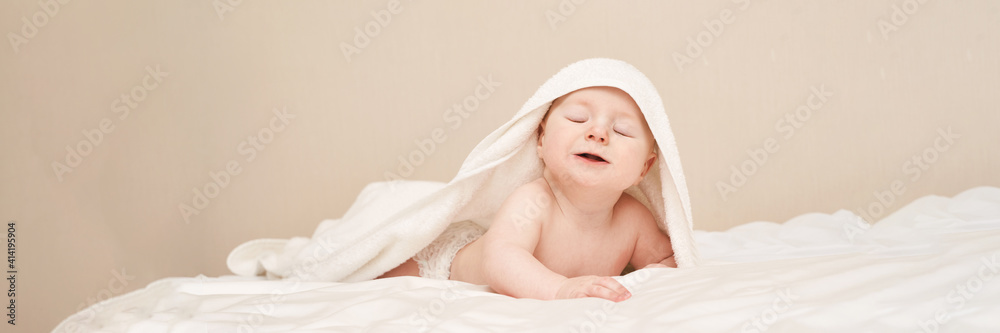 Cute small boy lying at bed. Childhood bath concept. Light background. Little child. Serious calm emotion. Copyspace. Stay home. Towel mockup. Closed eyes. Horizontal banner Cute small boy lying at bed. Childhood bath concept. Light background. Little child. Serious calm emotion. Copyspace. Stay home. Towel mockup. Closed eyes. Horizontal banner