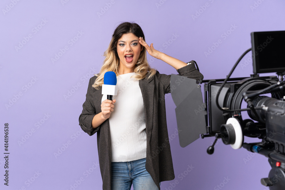 Reporter teenager girl holding a microphone and reporting news isolated on purple background with surprise expression Reporter teenager girl holding a microphone and reporting news isolated on purple background with surprise expression