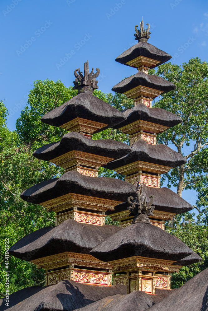 The architecture of the Hindu temple on the island of Bali in Ubud, Indonesia, Asia. High thatched roof tower The architecture of the Hindu temple on the island of Bali in Ubud, Indonesia, Asia. High thatched roof tower