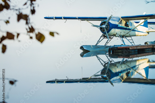 Beautiful reflection of a vintage float plane with fog in the background. 