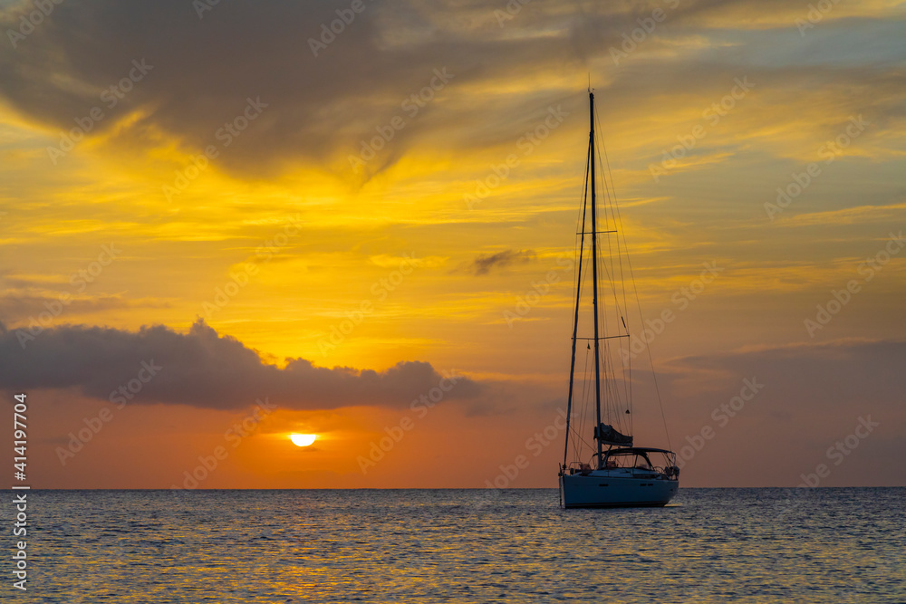 Caribbean, Grenada, Mayreau Island. Sailboat at anchor at sunset.