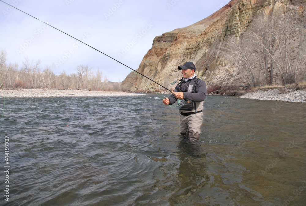 Fly fisherman casting for steelhead trout on the Salmon River in Idaho Fly fisherman casting for steelhead trout on the Salmon River in Idaho