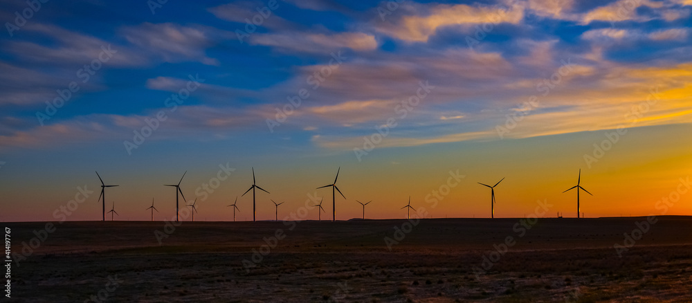 Fototapeta premium Wind turbines at sunset in the state of Idaho, Scenic view of wind turbines power generator