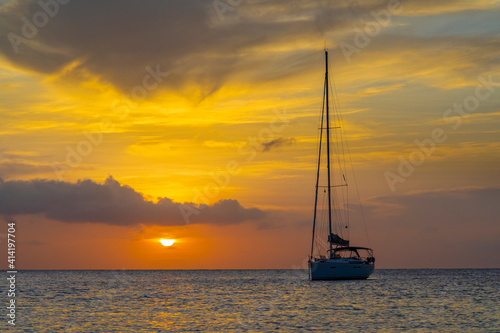 Caribbean, Grenada, Mayreau Island. Sailboat at anchor at sunset.