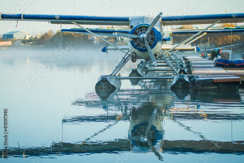Light mist in the distance with float planes resting at the dock.