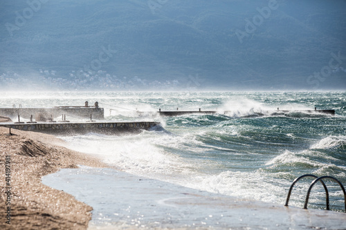 Severe weather at sea. Waves hit the coastline. Strong wind.