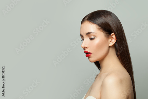 Healthy woman with makeup and straight hair on white background