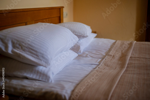 Fotografie bed in hotel room, pillows in the hotel, fresh clean linen on the bed, a hotel r