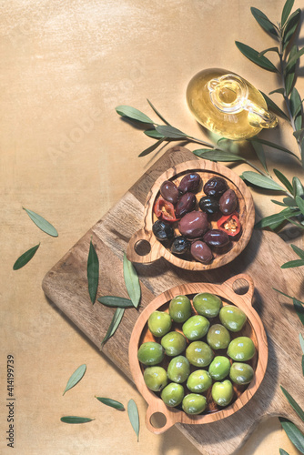 Mediterranean  background with pickled olives for the for tapas or antipasti in olive trees bowls  on the warm color table, top view, copy space 