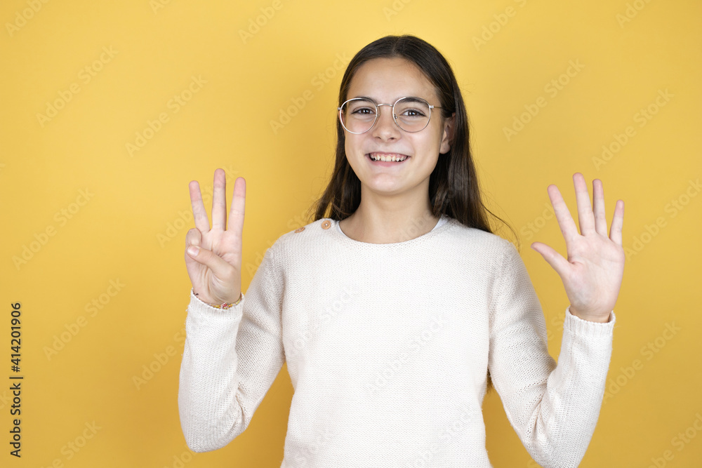 Beautiful child girl wearing casual clothes showing and pointing up with fingers number eight while smiling confident and happy Beautiful child girl wearing casual clothes showing and pointing up with fingers number eight while smiling confident and happy