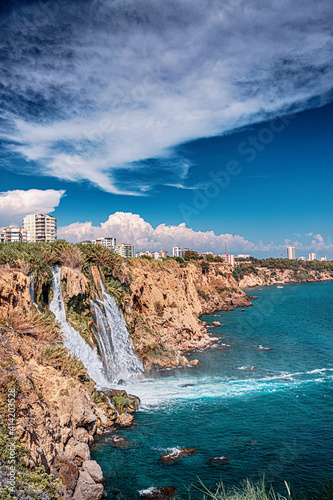 Fototapeta Naklejka Na Ścianę i Meble -  The picturesque and powerful Duden waterfall, a water stream breaks from a high cliff - this is a very popular place for tourists and a business card of Antalya and Turkey