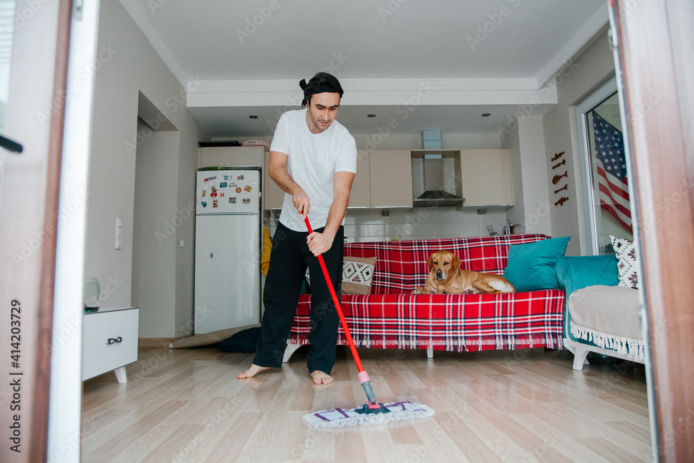 Man washing the floor. Doing chores concept. Mopping the floor. 
