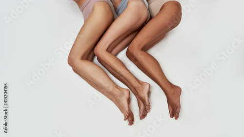 Women laying their legs on a studio floor