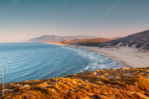 Fototapeta Naklejka Na Ścianę i Meble -  Morning view of the Mediterranean seacoast at the Patara beach during high tide with waves. High mesmerizing mountain in the background. Hidden natural wonders of Turkey