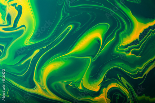 Colorful green and yellow marble abstract backround.Make up concept.Beautiful stains of liquid nail laquers.Fluid art,pour painting technique.Good as digital decor,copy space.Horizontal photography.