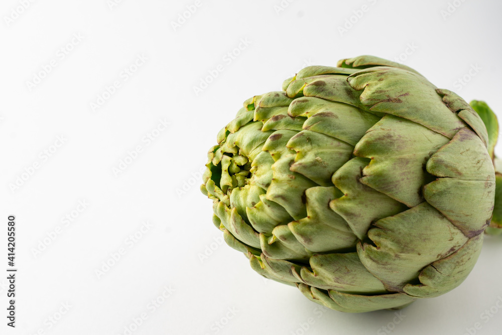 Fototapeta premium Close-up of whole artichoke, on white background, horizontal, with copy space
