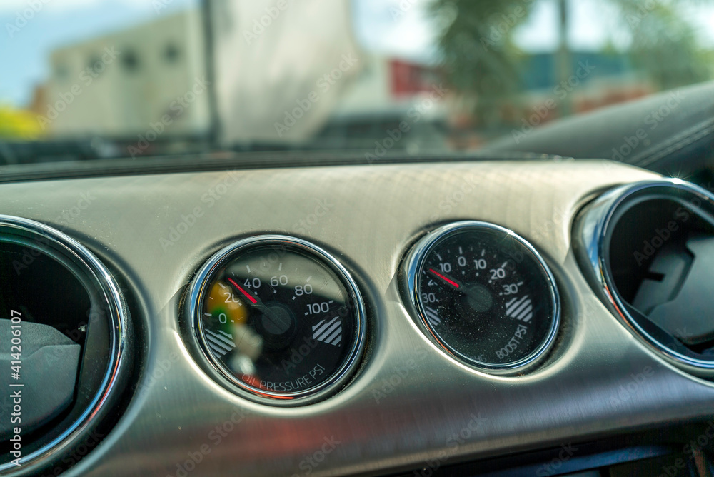Exotic car dashboard showing different gauges and Speedometer