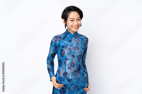 Young Vietnamese woman with short hair wearing a traditional dress over isolated white background laughing