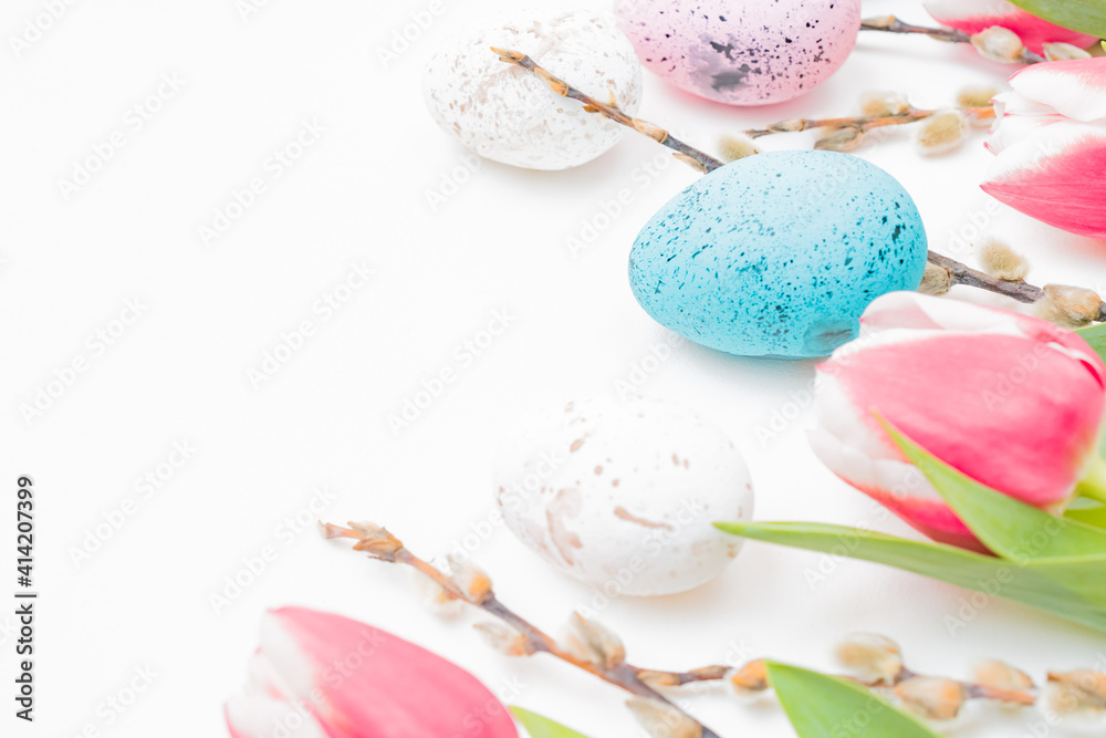 Easter composition with pink tulips and eggs on white background