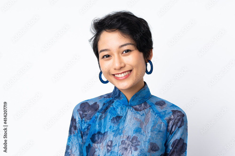 Young Vietnamese woman with short hair wearing a traditional dress over isolated white background Young Vietnamese woman with short hair wearing a traditional dress over isolated white background