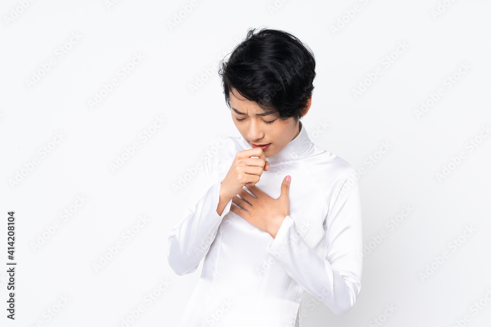 Young Vietnamese woman with short hair wearing a traditional dress over isolated white background coughing a lot Young Vietnamese woman with short hair wearing a traditional dress over isolated white background coughing a lot