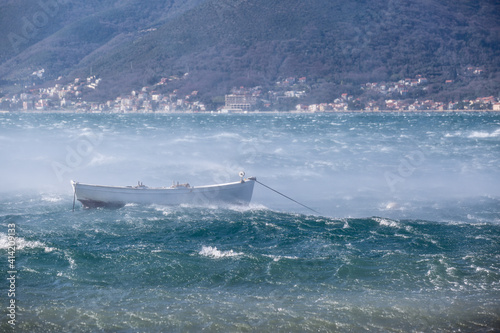 Small fishing boat at stormy sea