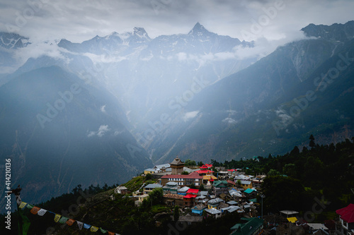 Kalpa village flanked by Himalayas and misty bright sky. Himachal Pradesh, India.