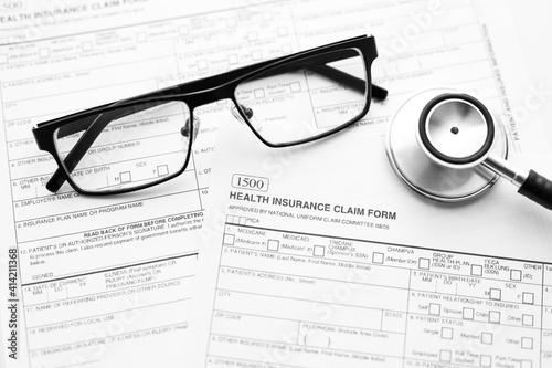 Health Insurance Claim Form. Individual medical health insurance policy with stethoscope and spectacles