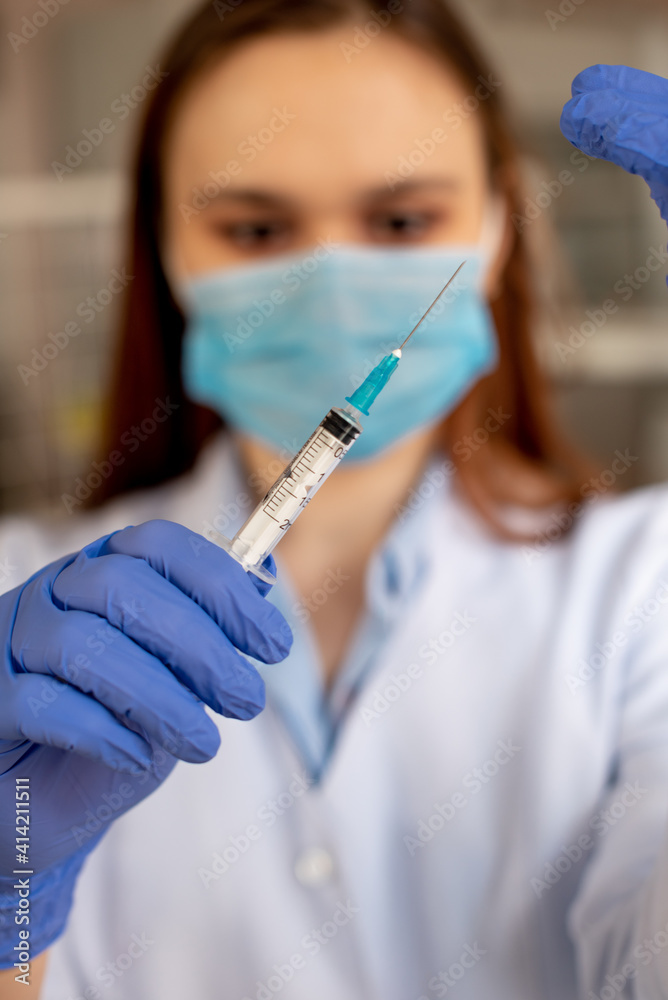 The nurse opens the syringe before the injection. Vaccination against coronavirus