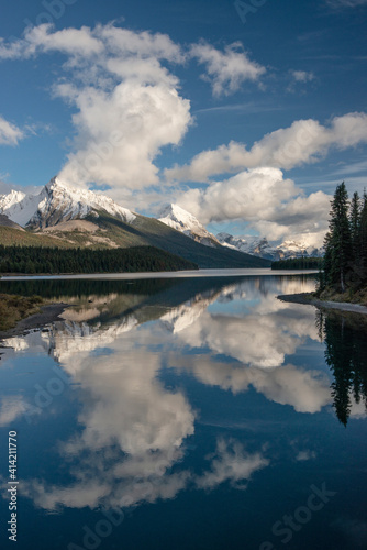 Canada, Alberta. Snow and cloud covered peaks surrounding Maligne Lake, Jasper National Park.