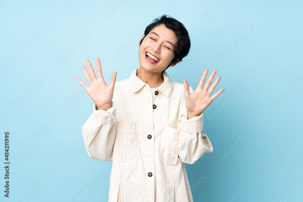 Young Vietnamese woman with short hair over isolated background counting ten with fingers Young Vietnamese woman with short hair over isolated background counting ten with fingers