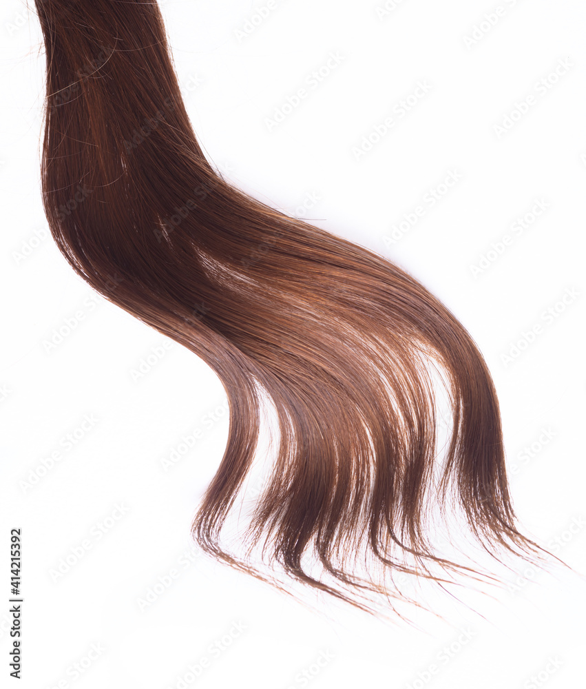 a lock of natural brunette hair on a white background a lock of natural brunette hair on a white background