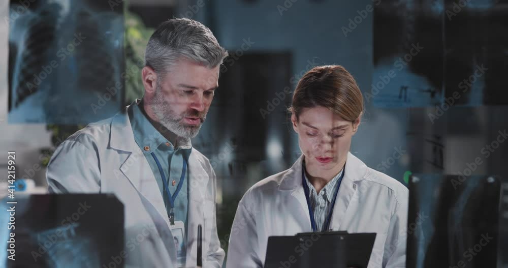 Hospitals. Caucasian handsome doctor and female nurse collaborating together writing notes discussing fly symptoms and coronavirus influenza.