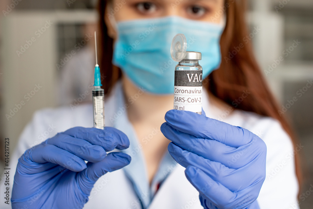 Medical laborant holding tube with nCoV Coronavirus vaccine for 2019-nCoV COVID virus. Coronavirus 2019-nCoV COVID concept.
