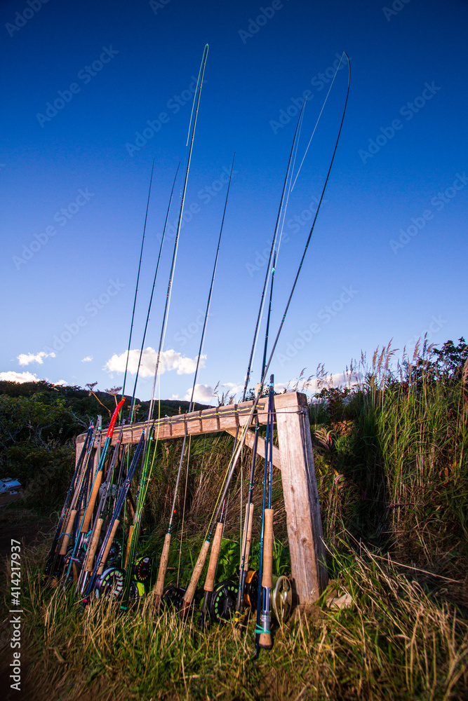 Fototapeta premium Fly rods and reels leaning against a post at a guide camp in Alaska.