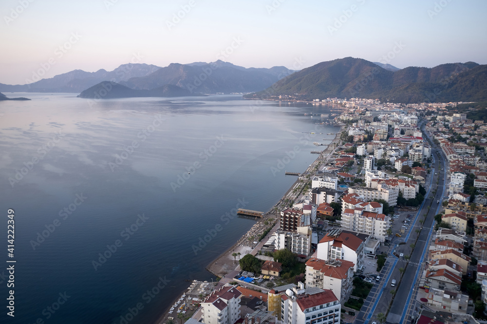 View over resort town of Marmaris, Turkey. Landscape with sea, buildings and mountains. Popular tourists destination.