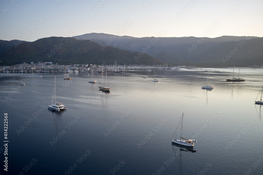 Yachting marina of resort town of Marmaris, Turkey. Ships in the sea harbor on the background of mountains. Yachting marina of resort town of Marmaris, Turkey. Ships in the sea harbor on the background of mountains.