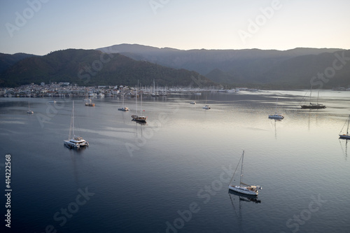 Yachting marina of resort town of Marmaris, Turkey. Ships in the sea harbor on the background of mountains.