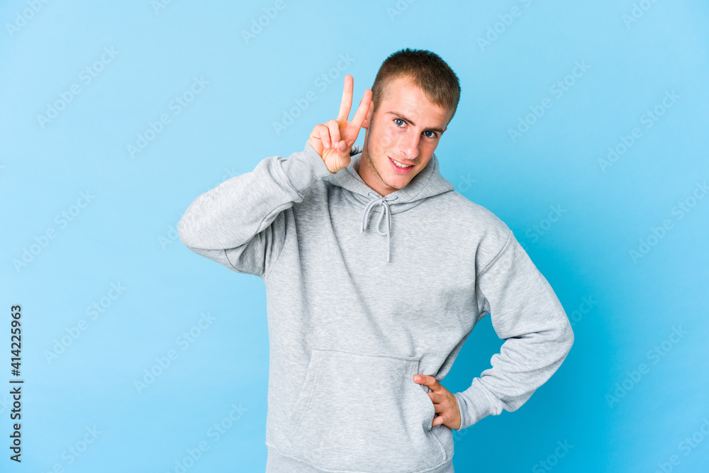 Young caucasian handsome man showing number two with fingers. Young caucasian handsome man showing number two with fingers.