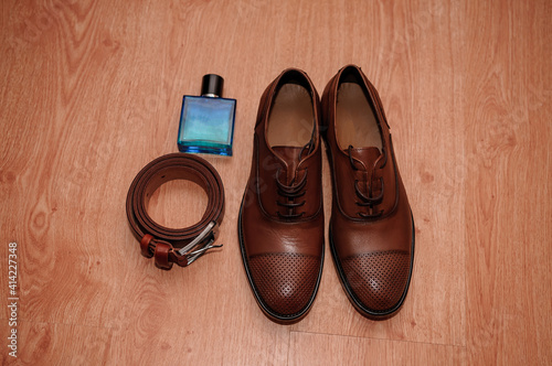 Brown men's shoes. belt. perfume. wedding rings. Groom's accessories