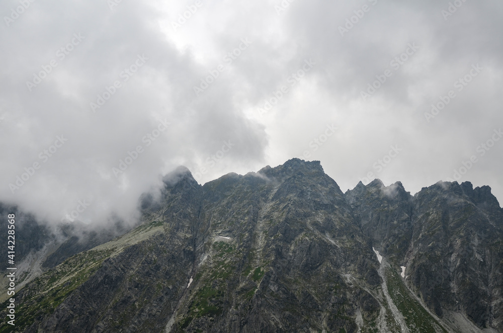 Beautiful landscape to Misty peaks and cloudy mountain Landscape during the day in High Tatras, Slovakia. Adventurer Concept