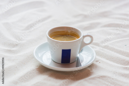 white cup with hot coffee on the table